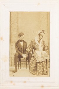 Two men, one in drag, sitting next to each other. Photograph, 189-.