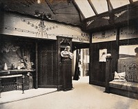 The 1904 World's Fair, St. Louis, Missouri: the Prague School for Arts and Crafts exhibit: an art nouveau interior with a decorative fireplace and wooden panelling. Photograph, 1904.