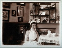 St Bartholomew's Hospital, London: a nurse taking tea. Photograph, c.1890.
