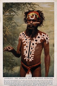 A shaman or medicine man with extensive body painting and nose stick, Australia. Colour process print.