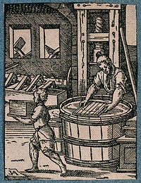 A man making paper; his apprentice carrying away the finished sheets. Woodcut by J. Amman.