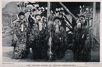 Four Kenyan shaman or medicine men dressed in ceremonial costume, South east Asia. Halftone.