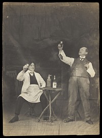 Two sailors pose on stage, holding up a drink. Photographic postcard, 191-.
