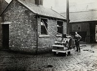 Fumigating a building (to destroy typhus-carrying lice ) with the Clayton Type B machine, England . Photograph, 1910/1930.