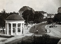 Franzensbad (Františkovy Lázně), Czechoslovakia: a small circular building with a domed roof which houses the Francis Spring, and the street leading away into the town beyond, seen from above. Photograph.