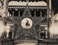 The 1904 World's Fair, St. Louis, Missouri: the Texas star: a large decorative star with an image of a cowboy at its centre, constructed from Texan agricultural produce. Photograph, 1904.