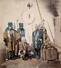 Japan: firemen in traditional dress. Coloured photograph by Felice Beato, ca. 1868.
