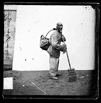 Peking, Pechili province, China: a collector of paper money. Photograph by John Thomson, 1869.