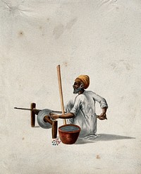 A man polishing semi-precious  stones. Gouache painting by an Indian artist.