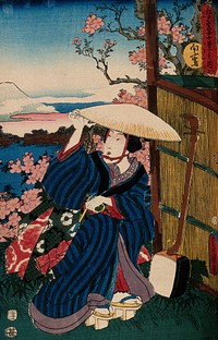 A kneeling woman in a broad straw hat, holding a pipe; a shamisen rests against the reed fence to the right; the view behind is a view of Fuji from Mukōjima. Colour woodcut by Kunisada, 1854.