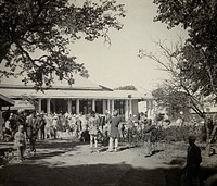 A hospital building, India , with men in turbans grouped outside. Photograph, 1900/1920.