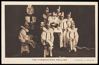 British prisoners of war, one in drag, posing for "The Timbertown Follies", at a prisoner of war camp in Groningen. Process print, 191-.