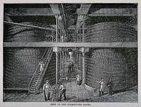 Fermenting backs and workers in a whiskey distillery. Wood engraving, late 19th century.