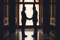 Two business men are hand shaking adult togetherness architecture.
