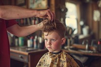 Boy getting a haircut in barber barbershop child hairdresser.