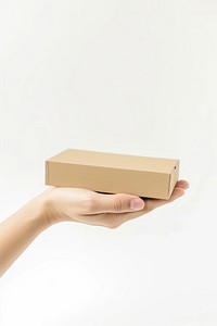 Hand hold beige flat card box cardboard carton white background.