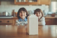 Milk carton child table girl.