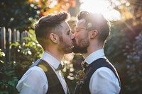 Gay couple kiss nature portrait outdoors.