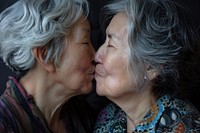 Older asian lesbian couple kiss portrait kissing adult.