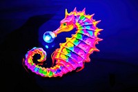 Black light oil painting of a seahorse purple yellow blue.