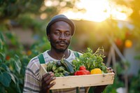 Young African Man with homemade vegetable box in hands adult outdoors portrait.
