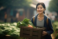 Chinese women carrying a vegetables box smile adult plant.