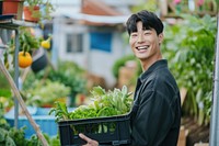 Young korean man carrying a vegetable box smile garden adult.