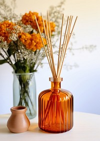 A burnt orange glass budget amber glass retro reed diffuser bottle vase jar.