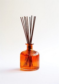 A burnt orange glass budget amber glass retro reed diffuser bottle vase white background.