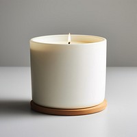 A white ceramic candle 3 wick with blank white label simplicity flowerpot cylinder.