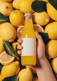Woman holding a bottle of lemon juice fruit plant food.