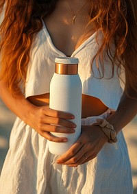 Woman holding a bottle of thermos summer photo refreshment.