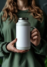 Woman holding a bottle of thermos refreshment container drinkware.