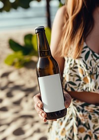 Woman holding a bottle of beer outdoors summer drink.