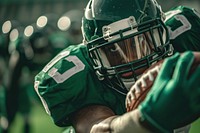 An American football player do touchdown helmet sports green.