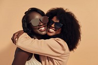 2 black woman hug sunglasses laughing portrait.