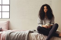 Woman thinking sitting bedroom cup.
