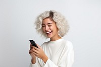 Woman holding a phone smile and laugh happy laughing adult white background.