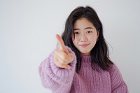 Young asian woman sweater gesturing happiness.