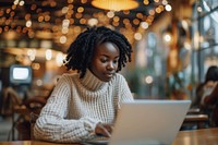 Woman working on a laptop computer adult cafe.