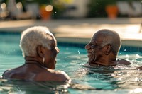 Senior friends talking bonding in swimming pool sports adult togetherness.