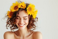 Woman with sunflowers in her hair laughing portrait smiling.