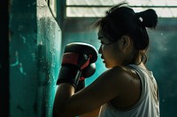 Woman getting ready for boxing practice punching sports determination.