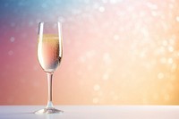 A glass of champagne on glitter gradient background cocktail drink wine.