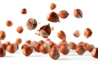 Falling hazelnuts food pill white background.