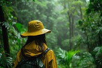 Woman in hiking clothe land raincoat outdoors.