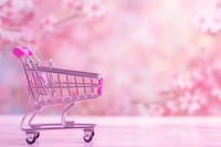 Pink shopping cart gradient background consumerism springtime fragility.
