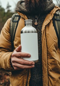Man holding a bottle of steel thermo refreshment container drinkware.