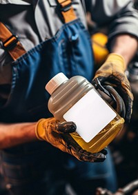 Man holding a canister with machine oil for car protection industry barista.