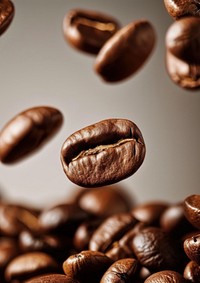 A coffee beans falling refreshment freshness abundance.